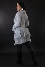 Woman wearing a gray knitted dress with ruffles on a white background